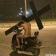 Illustration for article titled Oh Hey, Its a Naked Man on a Scooter, Carrying a Crucifix